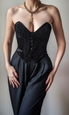 Incredible vintage bustier from the 1990s, a creation by the luxurious Italian corsetry house Ritmo di Perla. It is an exceptional piece, of impeccable quality, made in Italy. It is made from rich black velvet with a luxurious sheen, with inserts covered with silver threads that shine brightly. Velvet covered buttons decorate the front on the bust. The back is also shiny, and opens with an extremely discreet zipper. It has flexible but shaping underwires, allowing you to sculpt the silhouette bu Luxury Lace Trim Bustier Bodice, Luxury Bustier Bodice For Women, Luxury Romantic Bustier Bodice, Luxury Women's Underwire Corset, Luxury Shapewear Bustier, Luxury Bra-friendly Bustier, Luxury Sheer Bustier Corset, Luxury Nylon Bustier Corset, Luxury Formal Bustier Bodice