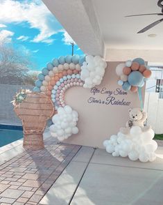 balloons and teddy bears are on display in front of a building