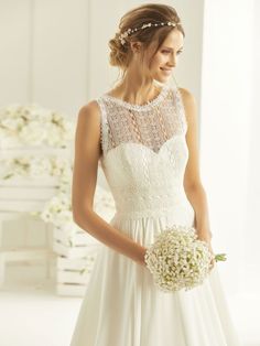 a woman in a wedding dress holding a bouquet