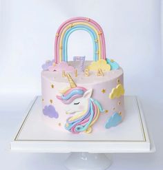 a cake decorated with an unicorn's head and rainbows