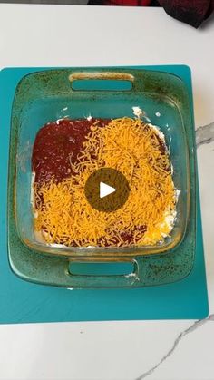 a green tray topped with cheese and sauce