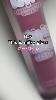 a pink tube with white lace on it and the words nyx this is milky gloss