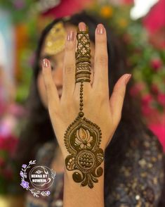 a woman's hand with henna tattoos on it