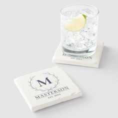 two personalized coasters with the letter m on them, and a lemon slice