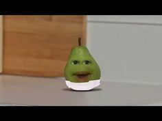 a green pear with a white bowl on it's head sitting on top of a counter