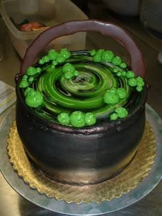 a cake with green frosting on top of a table