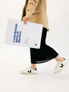 a woman walking while holding a large piece of paper