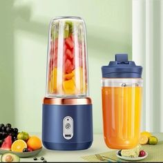 a blender filled with fruit sitting on top of a table next to a bowl of fruit