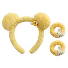 a set of two yellow ears and one ear ring with a pacifier attached to it