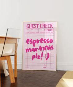 a pink sign sitting on top of a hard wood floor next to a white chair