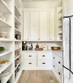 a kitchen with white cabinets and wood flooring is pictured in this image from the inside