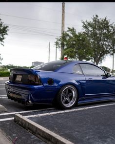 a blue sports car parked in a parking lot