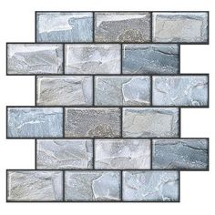 a white and gray mosaic tile wall with silver foil on the bottom, in an irregular pattern