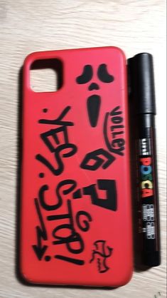 an iphone case with graffiti on it next to a marker