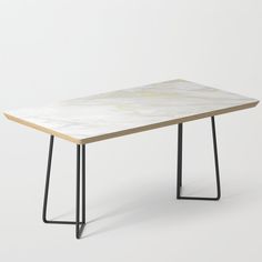 a marble table with black metal legs and a wooden top, on a white background