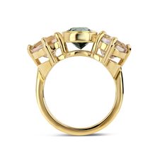 a yellow gold ring with three stones on the front and center stone in the middle