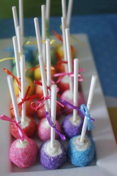 there are many candy candies on the plate with ribbons around them and tied together