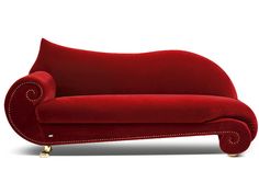 a red couch sitting on top of a white floor