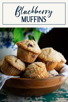 a bowl filled with muffins on top of a table next to blue flowers