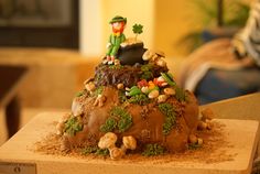 there is a cake that looks like a lepreite on top of the hill