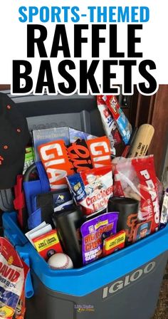 a blue trash can filled with sports themed raffle baskets and snacks on top of it