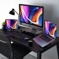 the computer desk has two monitors and a laptop on it