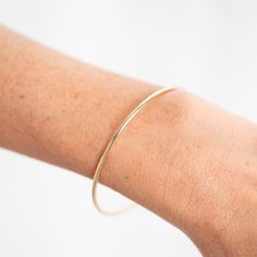 The Double Weight is almost two times the width of The Original bangle. Ideal for a perfectly round bangle with zero bounce. A 2mm round solid 14k gold bangle. Looking to buy 3 or more? Save with our Catch Up Pack. Solid Wire, Hammered Bracelet, Yellow Gold Bangle, Anniversary Dates, Gold Bangle, The Double, Gold Bangles, Custom Items, Custom Fit