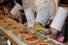 children in chef's hats are making pizzas