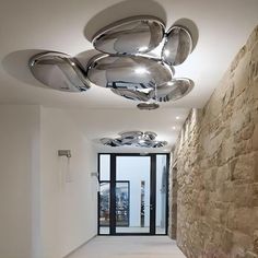 the ceiling lights in this hallway are very modern