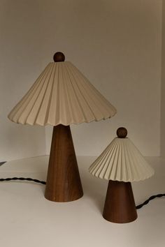 two lamps sitting on top of a table next to each other