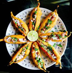 a white plate topped with french fries covered in sauce and garnished with cilantro