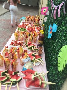 a table topped with watermelon and other foods