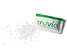 a packet of truvia powder next to it's contents on a white surface