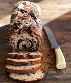 a loaf of chocolate chip banana bread next to a knife