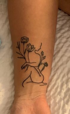 a woman's foot with a tattoo on it that has flowers in the middle