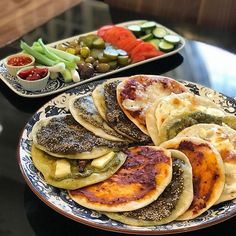 there are many different types of food on this plate, including pita breads