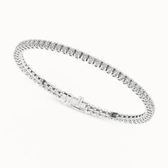 The Essential Tennis Bracelet exemplifies the magnificence of your beauty. Its string of glistening diamonds radiates luxury from every angle, and its minimalistic design makes you shine in all your glory. The diamond bracelet has a secured top GB lock that ensures the bracelet is secured and feels comfortable. Dazzling Platinum Tennis Bracelet With Jubilee Style, Dazzling Platinum Jubilee Tennis Bracelet, Dazzling Brilliant Cut Diamond Crystal Bracelet, Luxury Diamond Chain Bracelet With Brilliant Cut, Luxury Brilliant Cut Diamond Chain Bracelet, Elegant Diamond Crystal Bracelet With Brilliant Cut, Classic White Gold Crystal Bracelet With Cubic Zirconia, Elegant Diamond Crystal Bangle Bracelet, Classic White Gold Cubic Zirconia Crystal Bracelet