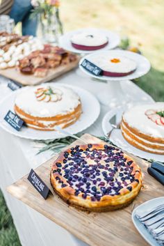 a table topped with lots of different types of cakes and pies on top of plates