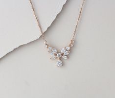 "A simple but glamorous rose gold bridal necklace to add a touch of sparkle to your wedding! This necklace features an array of intricately cut Swarovski Pure Brialliance CZ stones that shine brilliantly! Perfect for the bride or a bridal party ! Size: 17\" (Length) 1/16\" (Width) 3/4\" (Drop) You can choose a backdrop for this piece as well, please choose from the drop down menu. Any of my CZ earrings will match beautifully with this necklace" Rose Gold Cubic Zirconia Diamond Necklace For Wedding, Delicate Rose Gold Cubic Zirconia Bridal Necklace, Delicate Rose Gold Diamond Necklace For Wedding, Delicate Rose Gold Cubic Zirconia Necklace, Rose Gold Necklace With Delicate Chain For Bridesmaid, Rose Gold Delicate Chain Necklace For Bridesmaid, Dainty Rose Gold Bridal Necklace For Anniversary, Dainty Rose Gold Necklace For Bridesmaids, Delicate Diamond Necklace With Adjustable Chain For Wedding