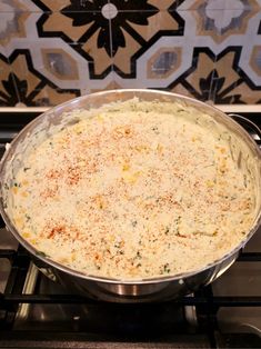 a pan filled with food sitting on top of a stove