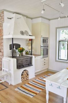 a kitchen with an oven, table and chairs