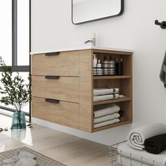 a bathroom with white walls and wooden cabinet in the middle, towels on the shelf next to it