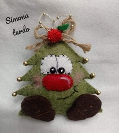 a green christmas tree ornament with a red nose and nose on it's head