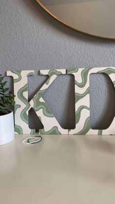 the letters are made out of wood and have wavy shapes