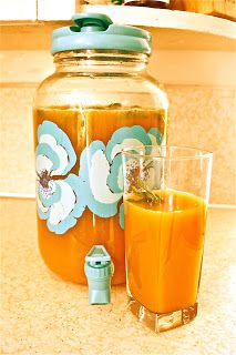 there is a mason jar with orange juice in it