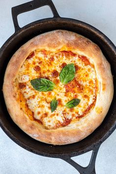 a pizza sitting in a pan on top of a stove