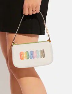 a woman is holding a white purse with the word garbh printed on it