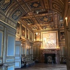 an ornately decorated room with blue walls and gold trim