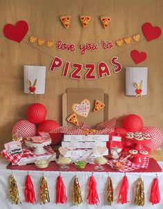 a pizza themed birthday party with red and gold decorations, paper heart garlands and tassels