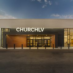 an empty parking lot in front of a building with the word church written on it